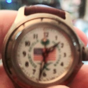 A woman's desert storm watch with ma  leather band.